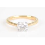 An 18ct gold diamond single stone ring, the four claw set brilliant weighing 0.6 carats, colour