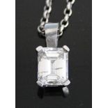 A white metal emerald cut diamond single stone pendant, in a four-claw setting with solid bale and