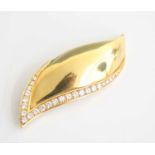 A yellow metal diamond set leaf brooch, comprising 26 graduated round brilliant cut diamonds in
