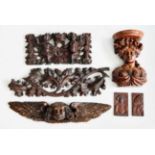 A collection of carved furniture mounts, to include an 18th century carved oak winged mask, w.