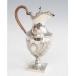 A late Victorian silver wine ewer, of stepped baluster form with repousse cast lower section