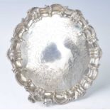 A mid-Victorian silver salver, of shaped circular form with shell and scrolling rim and engraved