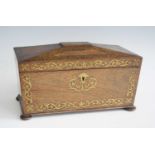 A Regency rosewood and brass inlaid tea caddy, of sarcophagus form, the interior fitted with twin