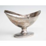 A George III silver swing handled bonbon basket, of elliptical form with reeded rim and handle,