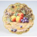 A Royal Worcester porcelain low comport, decorated with fruit on a mossy bank by T Lockyer,