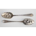 A pair of Regency silver berry spoons, the scallop edged bowl repousse decorated with fruit, the