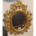 A 19th century small Italian floral carved and gilt framed oval wall mirror, 40 x 35cm