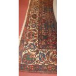 A large Persian woollen red ground Tabriz rug, having all-over heavy geometric floral decorated