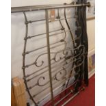 A modern tubular metal double bedstead, having side rails, central section, and slats