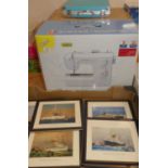 A boxed Singer Symphony sewing machine, various table mats, and a box containing photo binders
