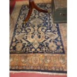 A Persian woollen navy blue ground Shiraz rug, 235 x 173cm