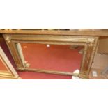A circa 1900 gilt wood over mantel mirror, having a proud reeded and floral decorated border, 69 x