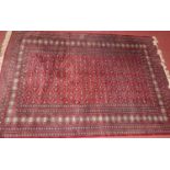 A Persian woollen red ground Bokhara rug, 188 x 128cm