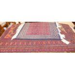 A Persian woollen red ground prayer rug, 112 x 81cm; together with a small Persian woollen red