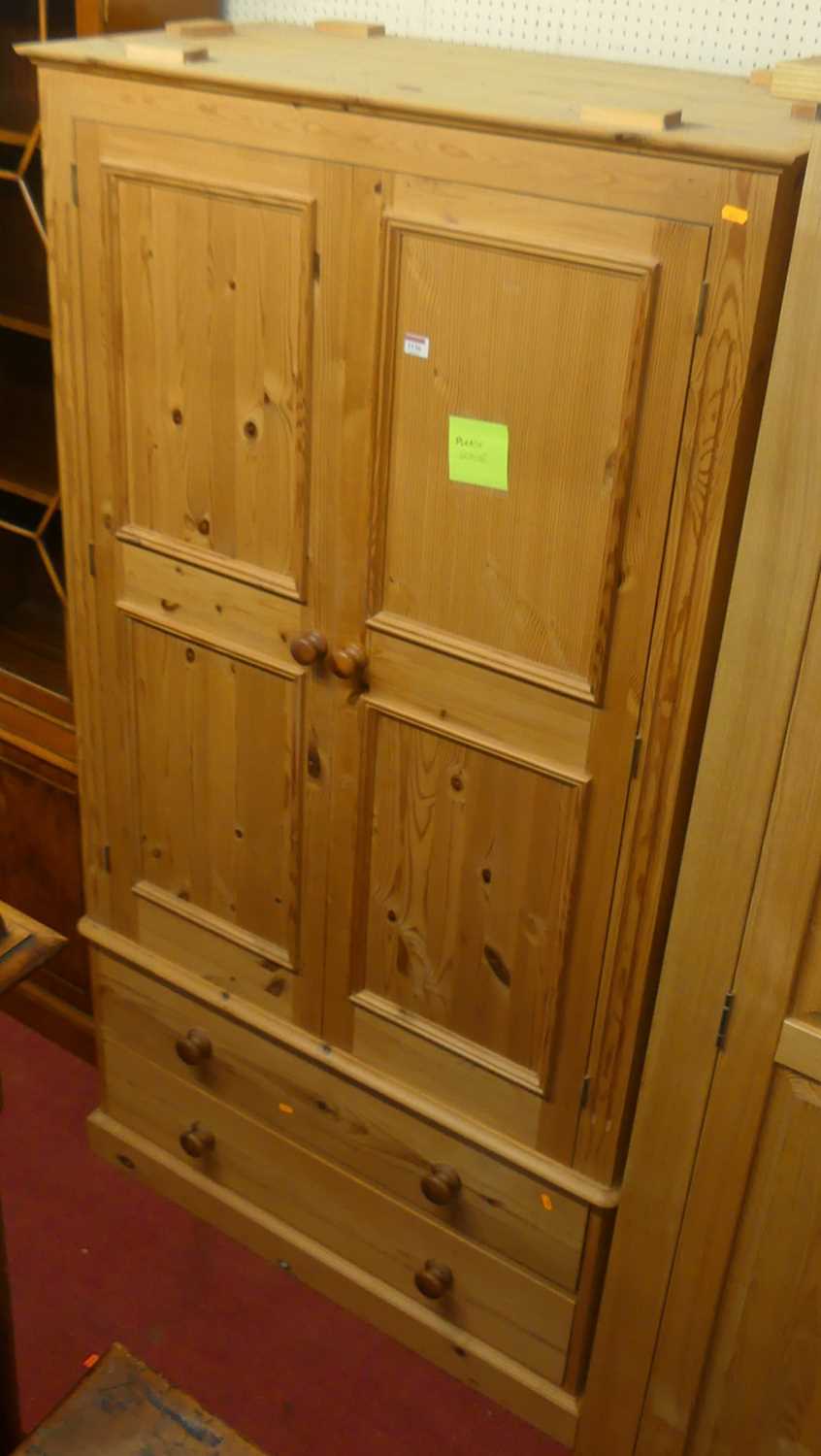 A modern pine double door wardrobe, having twin long lower drawers, width 100cm