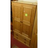 A modern pine double door wardrobe, having twin long lower drawers, width 100cm