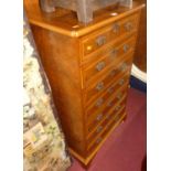 A contemporary figured walnut and crossbanded narrow chest of seven long drawers, in the Georgian