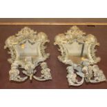 A pair of pierced gilt metal girandoles, each of floral cast outline with bevelled shaped inset