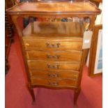 An Edwardian mahogany and satinwood inlaid five drawer music chest, with raised serpentine shaped