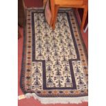 A small Persian woollen cream ground rug, having a repeating central ground, 145 x 84cm
