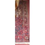 A Persian woollen red ground Tabriz rug, 330 x 205cm