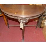 A circa 1900 Continental walnut demi-lune side table, raised on carved and cylindrical tapering