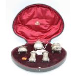 A George V five-piece cruet set, comprising pair of pedestal pepperettes, pair of open salts, and