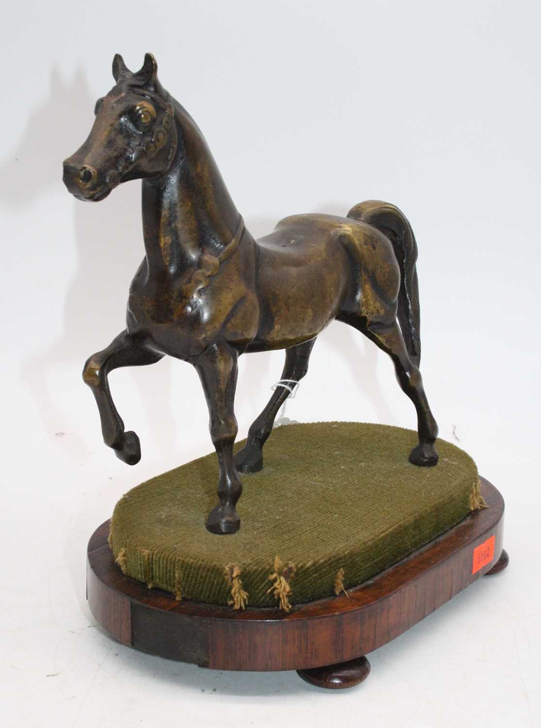A bronze model of a horse, mounted upon a rosewood plinth, h.24cmThe horse and base appear to be a