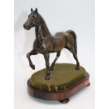 A bronze model of a horse, mounted upon a rosewood plinth, h.24cmThe horse and base appear to be a