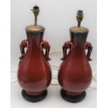 A pair of Chinese sang-de-boeuf vases, later converted for electricity, h.48cm