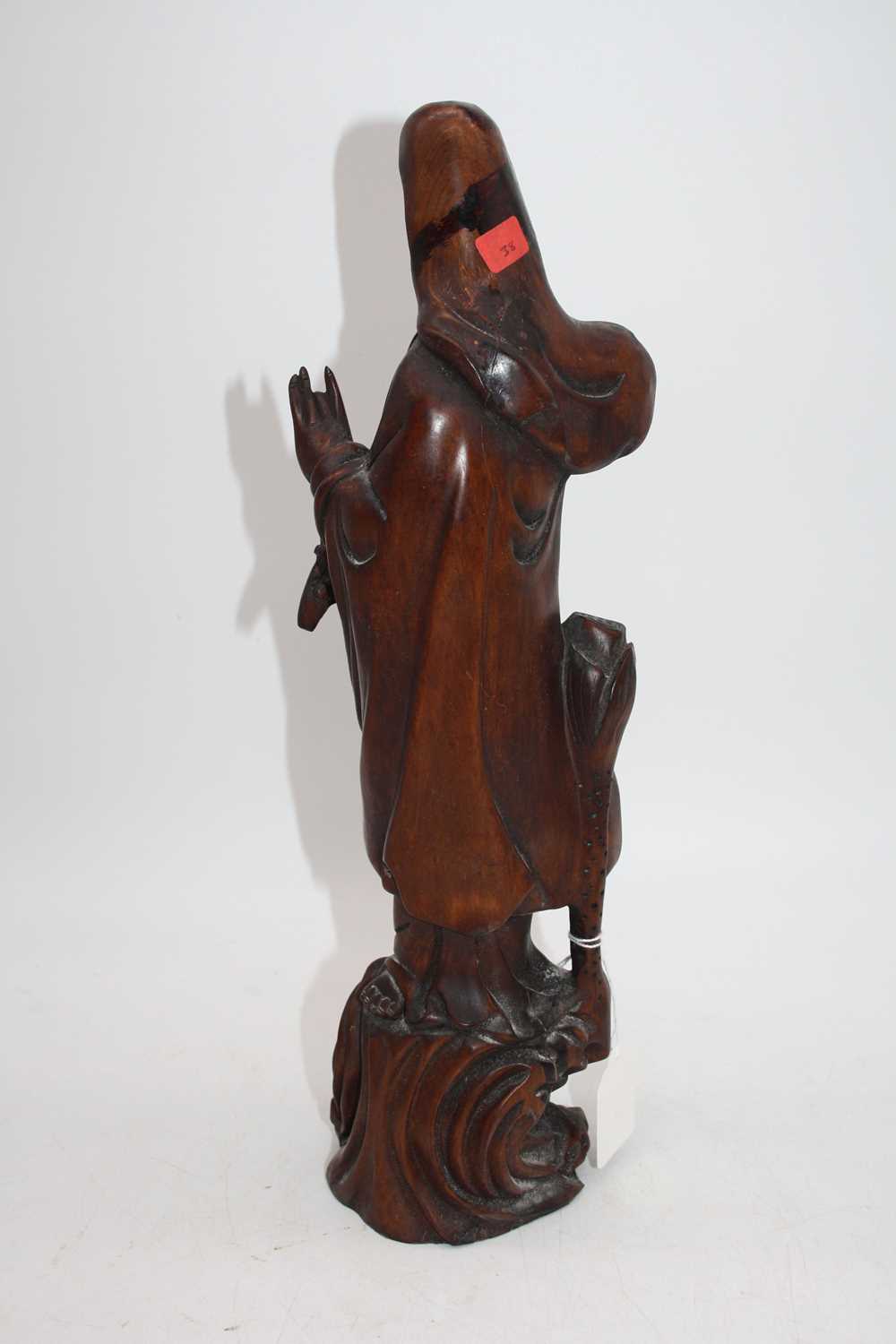 An Eastern carved wood figure of Guanyin, h.39cmSeveral splits to the timber.Some signs of - Image 2 of 2