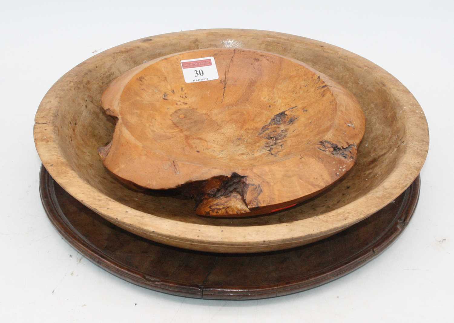 A 19th century mahogany circular tray, dia.33cm; together with two treen bowlsExtra images