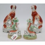 A pair of 19th century Staffordshire figures of gun dogs, each in seated pose with game bird at