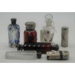 A late Victorian double ended scent bottle, having a cranberry facet cut body with white metal caps;