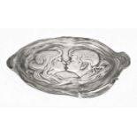 A WMF repousse decorated pewter dish, depicting a young couple, w.28cm