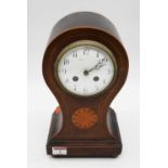 An Edwardian mahogany and boxwood strung balloon shaped eight day mantel clock, the enamel dial