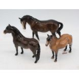 A Beswick model of a mare facing left, model No. 976 brown gloss, height 17cm, together with two