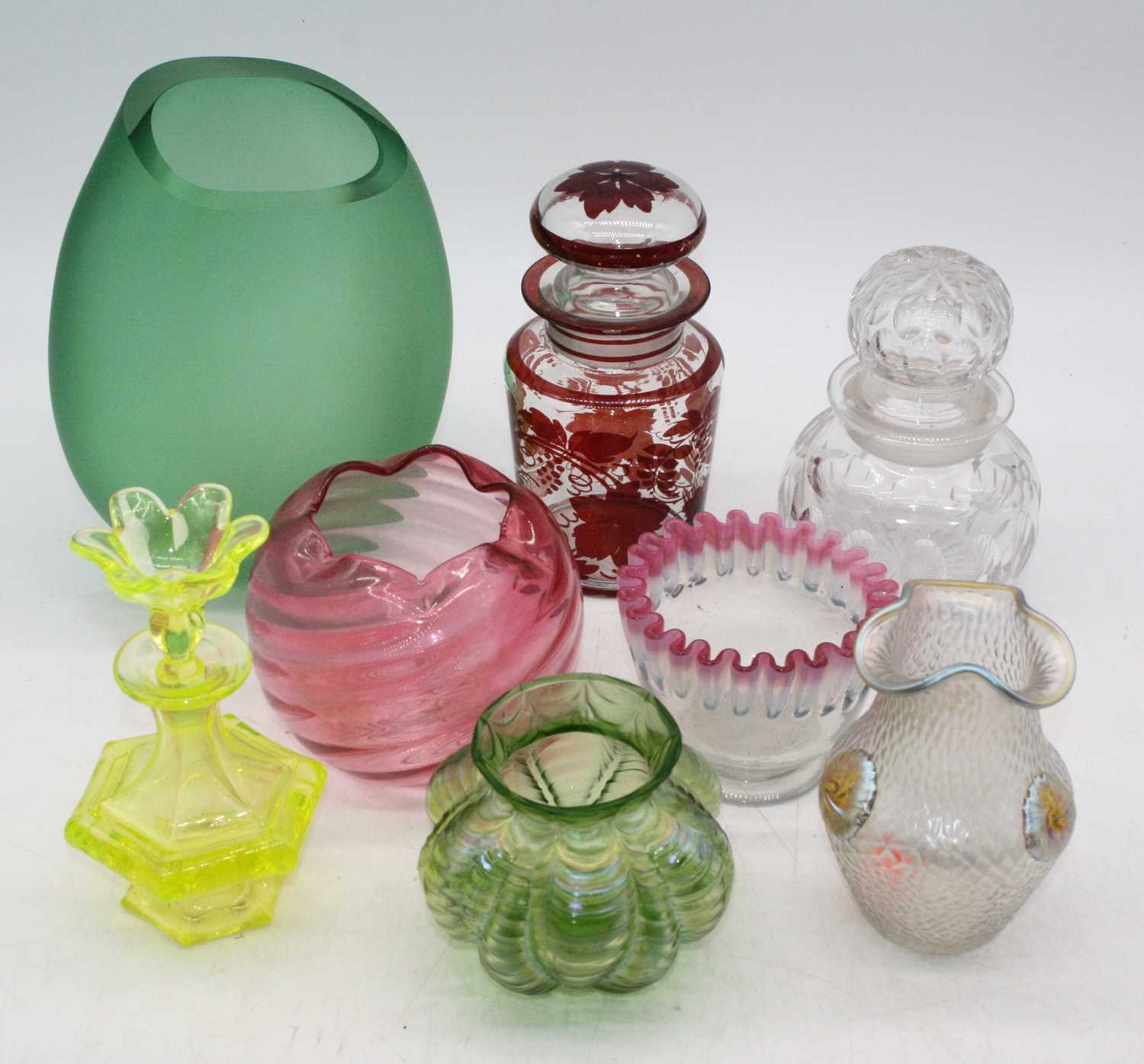 A collection of coloured glassware to include a Loetz style iridescent glass vase, height 12.