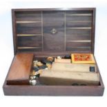 A 19th century mahogany cased games compendium, containing games pieces for draughts, dominoes and
