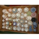 A collection of miniature teacups and saucers to include Crown Derby and Wedgwood