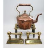 A Victorian copper range kettle, h.25cm; together with a pierced brass trivet; and a pair of brass