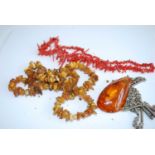 An amber multi small stone necklace, large clear amber pendant; together with a coral necklace (3)