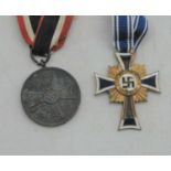 A Cross of Honour of the German Mother; together with a German War Merit medal (2)We believe these