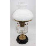 A 19th century oil lamp, having milk glass shade and faceted clear glass font, overall h.55cm