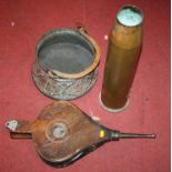 A brass artillery shell case together with an eastern copper pot, and a pair of bellows