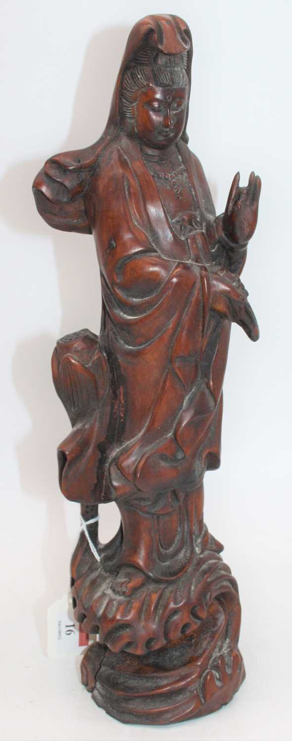 An Eastern carved wood figure of Guanyin, h.39cmSeveral splits to the timber.Some signs of