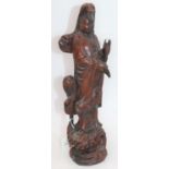 An Eastern carved wood figure of Guanyin, h.39cmSeveral splits to the timber.Some signs of