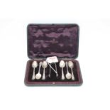 A set of six Edwardian silver teaspoons; together with a pair of matching sugar tongs in fitted