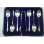 A cased set of six Edwardian silver apostle teaspoons and sugar bows, maker Mark Wallis & Son,