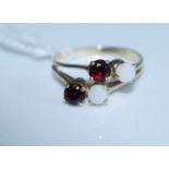 A modern yellow metal, garnet and opal set dress ring, stamped 14k, 2.6g, size L